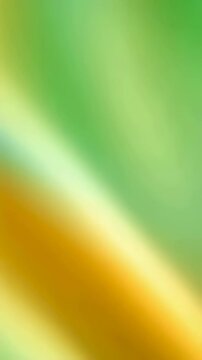 Moving diagonal vibrant green and yellow abstract blurred gradient background with light transition, seamless loop for screen saver Vertical video