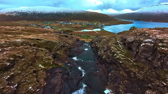 Aerial view of scenic fjor village with stream and bidge in Faroe Islands