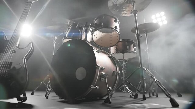 Rock Band Stage Setup with Guitar and Drum Kit Under Bright Spotlights and Haze.