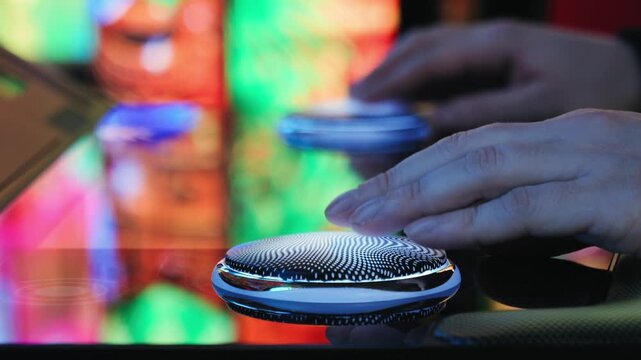 A man is playing slots machine and roulette or poker, gambling in casino close up, game machine in cafe or hotel lobby. Playing betting game.