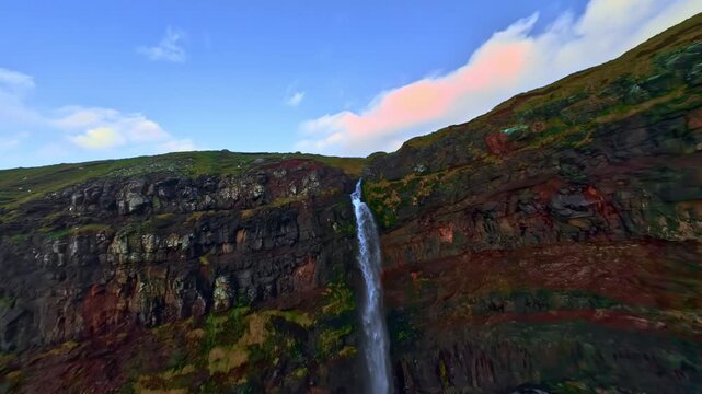 Iconic aerial view of Mulaossur waterfall in Gasadalr at sunset