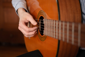 Fototapeta premium A close up of a man plucking his guitar