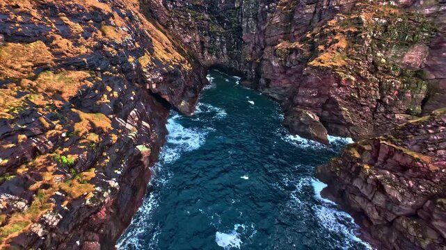Dramatic sea cliffs and stcks with deep blue ocean cve aerial view