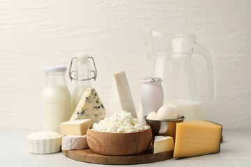 Different dairy products on white tiled table