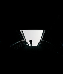 man with umbrella in a dark tunnel