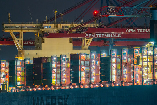 Gothenburg, Sweden - december 04 2022: Container ship operations at APM terminals port during night.