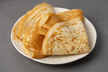 Traditional Russian pancakes on a grey table. Homemade russian thin pancakes blini. Russian food, russian kitchen