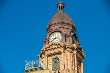 Obraz premium Close Up of Courthouse Building With Tall Clock Tower in Historic City of Fort Worth Texas Blue Sky