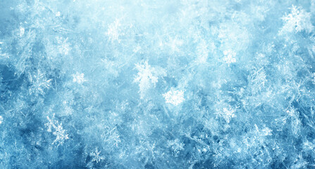 Macro photography of delicate ice and hoarfrost crystals forming natural snowflake patterns on a deep blue winter background, ideal for seasonal, cold, and abstract concepts.