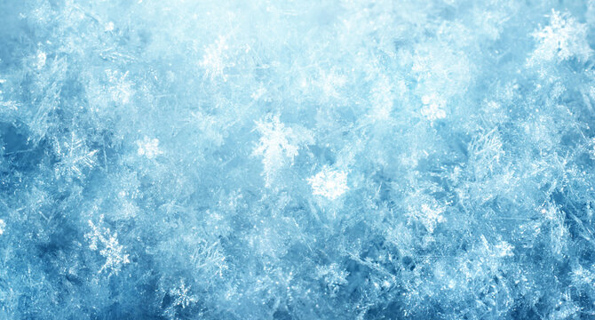 Macro photography of delicate ice and hoarfrost crystals forming natural snowflake patterns on a deep blue winter background, ideal for seasonal, cold, and abstract concepts.