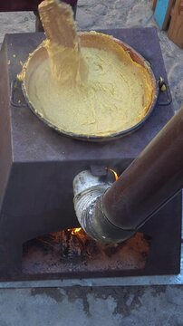  italian traditional food polenta, preparation in Rango, Trentino Italy, wooden fire and copper pot