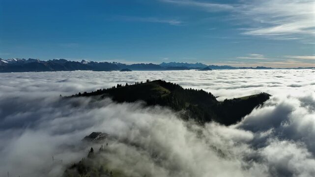 Drone flight over mountainforest looking at sea of couds horizon