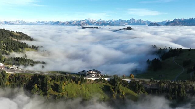 Aerial view of mountain reort and ridge above vast sa of clouds