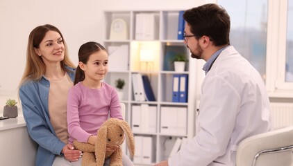 Little girl and her mother having appointment with doctor in hospital