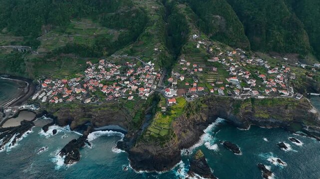Aerial panorama of Seixal village and Atlantic coastline. Residential buildings positioned along elevated coastal landforms