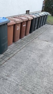 A row of plastic containers for sorting waste on the street