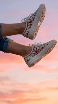 Close-up of stylish white canvas shoes featuring delicate floral embroidery, perfect for casual wear and outdoor adventures