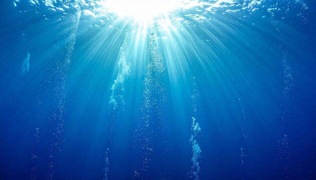 Rayos de sol atraviesan el agua azul profunda, iluminando burbujas que ascienden hacia la superficie en un paisaje submarino sereno y radiante.