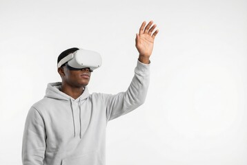 Young man wearing VR headset reaching up with hand against white background