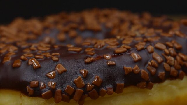 Close-up panning shot of delicious chocolate sprinkle donuts. Perfect for food commercials, bakery promotions, or sweet snack themes.