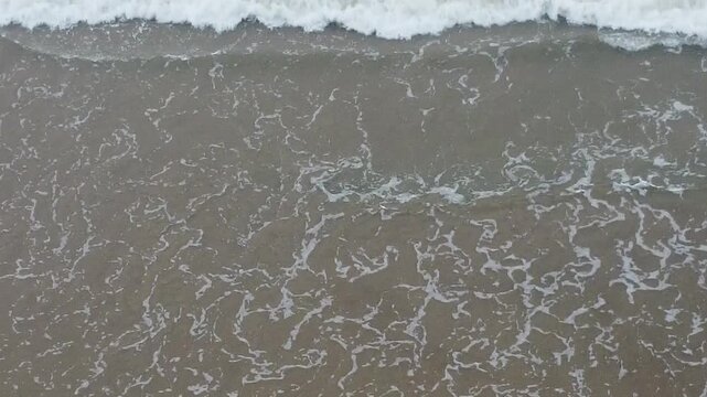 aerial top view drone video clip of scenic wave formation in a sea beach of famous travel destination city Puri in India