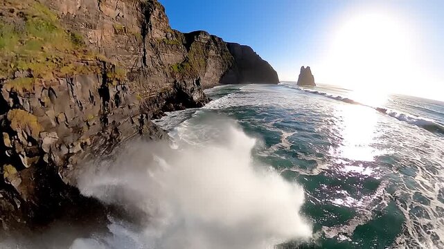 Cinematic FPV drone tracking parallel to dramatic coastal cliffs, ocean waves crashing below,