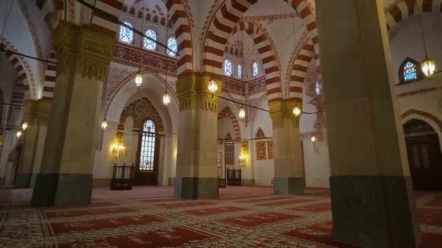 4K footage of mosque interior details such as arches and columns softly lit, empty space, respectful and peaceful Ramadan environment