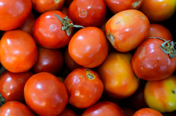 Fresh red tomatoes background Organic vegetables for healthy lifestyle and cooking.