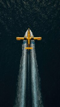 Yellow Seaplane Scooping Water for Firefighting