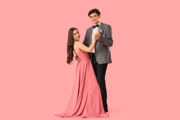 Pretty prom couple dancing valse on pink background © Pixel-Shot