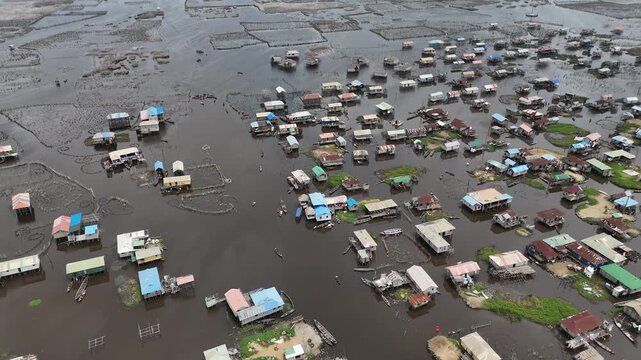 aerial perspective of Ganvie, revealing the unique urban layout of wooden stilt houses built over the waters of Lake Nokoue
