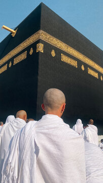 Rear View Of Muslim With Shaved Head Standing Before The Holy Kaaba