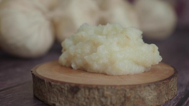 closeup of garlic paste on a wooden board 