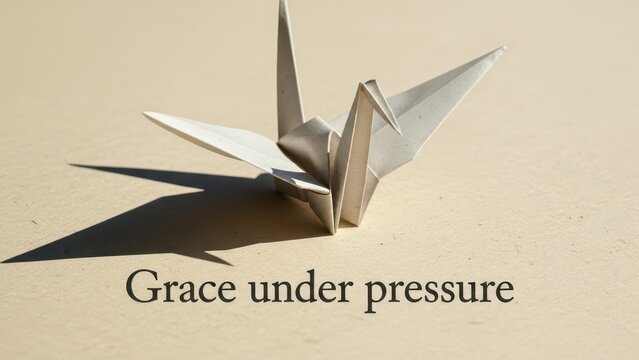 Elegant origami crane crafted from paper, symbolizing grace under pressure with delicate folds and soft shadows.