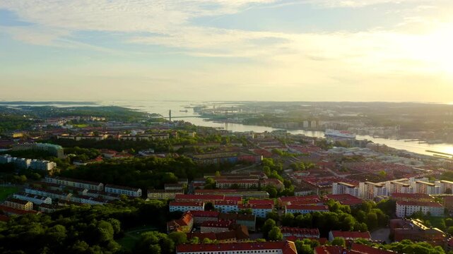 Gothenburg, Sweden. Panorama of the city and the river Goeta Elv with ships. Sunset. Drone footage
