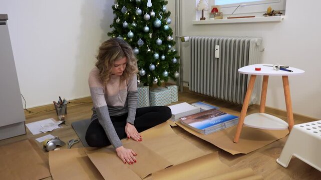 Woman Wrapping Calendars as a Christmas Gifts. Slow Motion