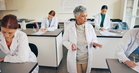 Obraz premium Teacher, students or speaking in classroom for education, science lesson or explain chemistry experiment. Learn, people or teens writing notes for physics, knowledge or instruction for lab assessment