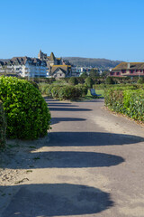 Obraz premium Residential landscape of Deauville in France with open green space and traditional architecture, springtime scene with soft sunlight and well kept park environment
