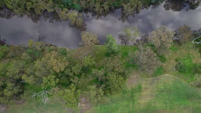Aerial view moving forward from one side of the Yara River and looking straight down, Studley Park in Melbourne, Victoria, Australia. December 2025