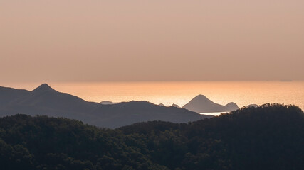 Golden Sunset Over Mountain Silhouettes by Ninepin Group