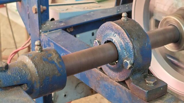 Mechanical worm gear rotating inside a traditional corn dough mill.