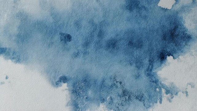Abstract blue watercolor washes on textured white paper