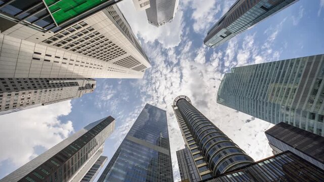 Blue sky and clouds reflecting over skyscrapers facades in Financial District in New York City 4k View