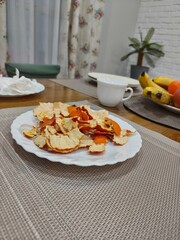 Plate with tangerine peels on table after eating. Concept of healthy eating and natural fruit snack.