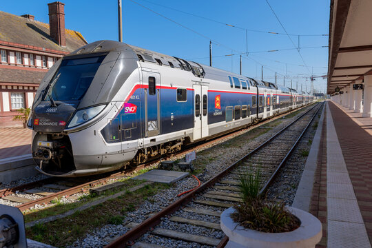 Deauville, France - 30 march 2025. Passenger train standing on platform in Deauville France, quiet railway scene with tracks and open space under soft daylight