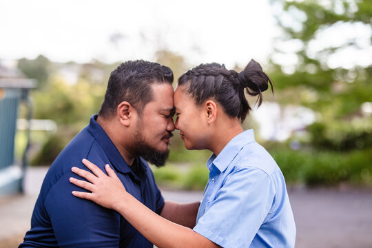 Samoan father and daughter greeting each other with traditional gesture