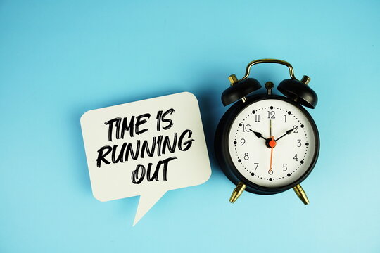 Time is Running Out text on speech bubble with alarm clock on blue background