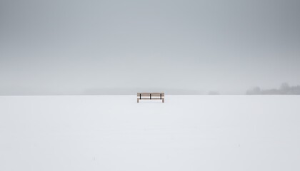 Snow-Covered Minimalist Wooden Bench on a Serene Winter Field with Overcast Sky and Copy Space for Branding
