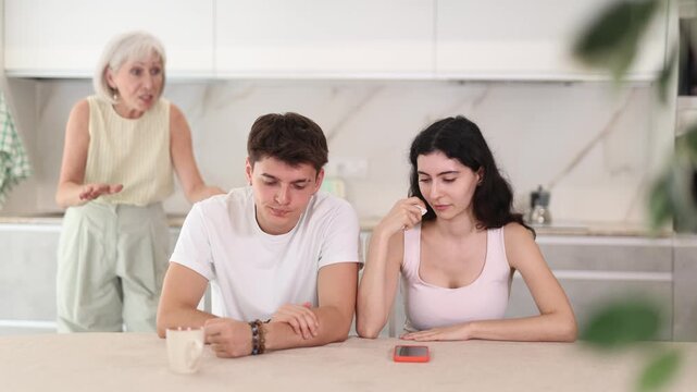 Elderly woman swears at young married couple. Complex intergenerational relationships 