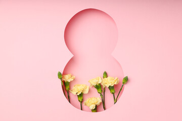 Obraz premium Colorful flowers are displayed behind a pink cutout number eight